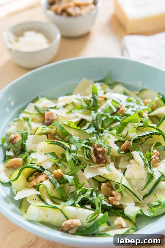 20+ Picnic and Potluck Salads That Stay Fresh and Travel Well 9 Zucchini Ribbon Salad - With Basil, Walnuts, and Grana Padano in Blue Bowl