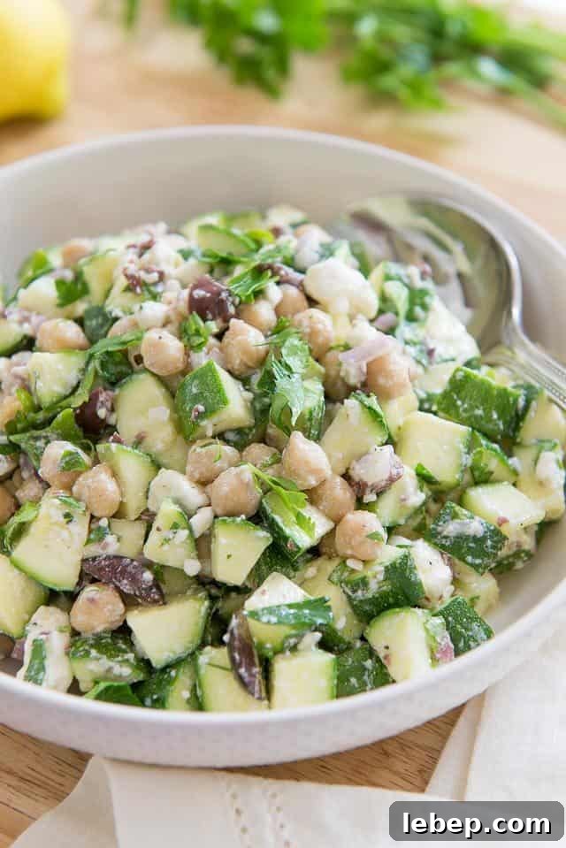 20+ Picnic and Potluck Salads That Stay Fresh and Travel Well 10 Zucchini Salad - With Raw Zucchini Chunks, Chickpeas, and Olives in Bowl