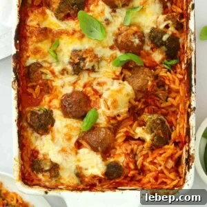 A dish straight out of the oven for the recipe Meatball Orzo Bake.