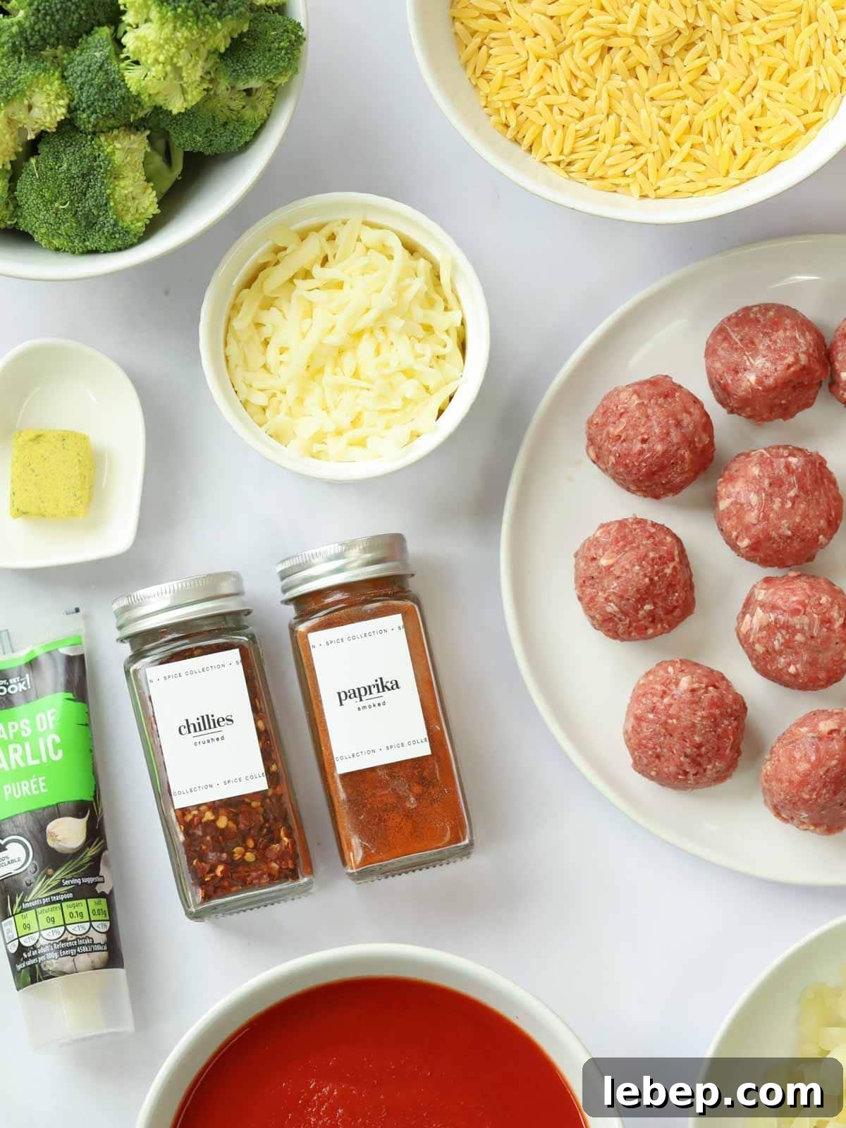 Ingredients for a meatball orzo bake recipe all laid out on a counter.