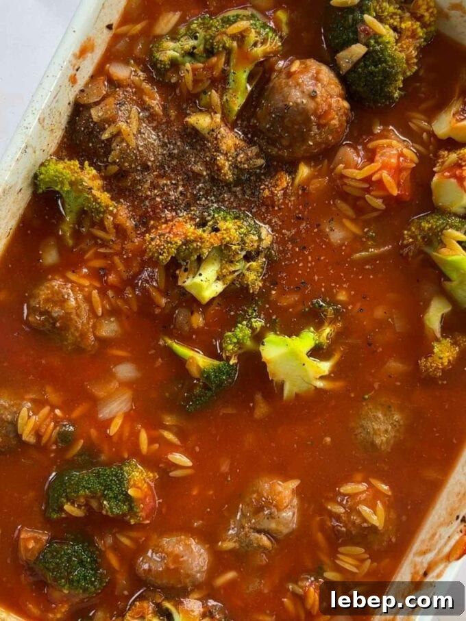 How to make Meatball Orzo Bake, step 2. Broccoli, orzo and meatballs in a dish, ready to go in the oven.
