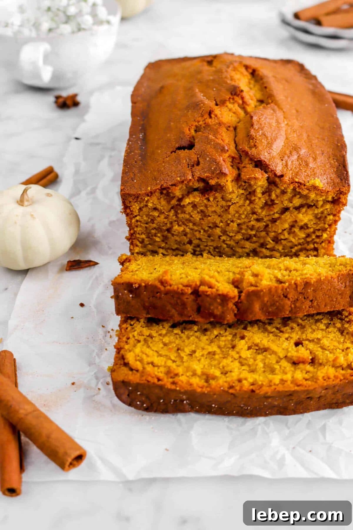 Moist Pumpkin Bread Recipe with Warm Spices 18 close up of two slices laying in front of pumpkin loaf