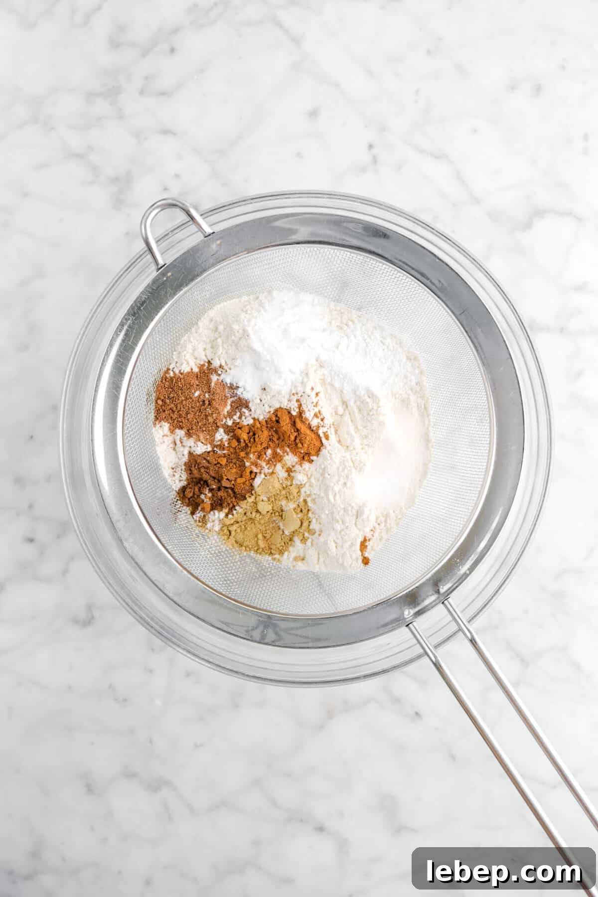 Moist Pumpkin Bread Recipe with Warm Spices 7 flour, spices, salt, baking powder, and baking soda in large sieve