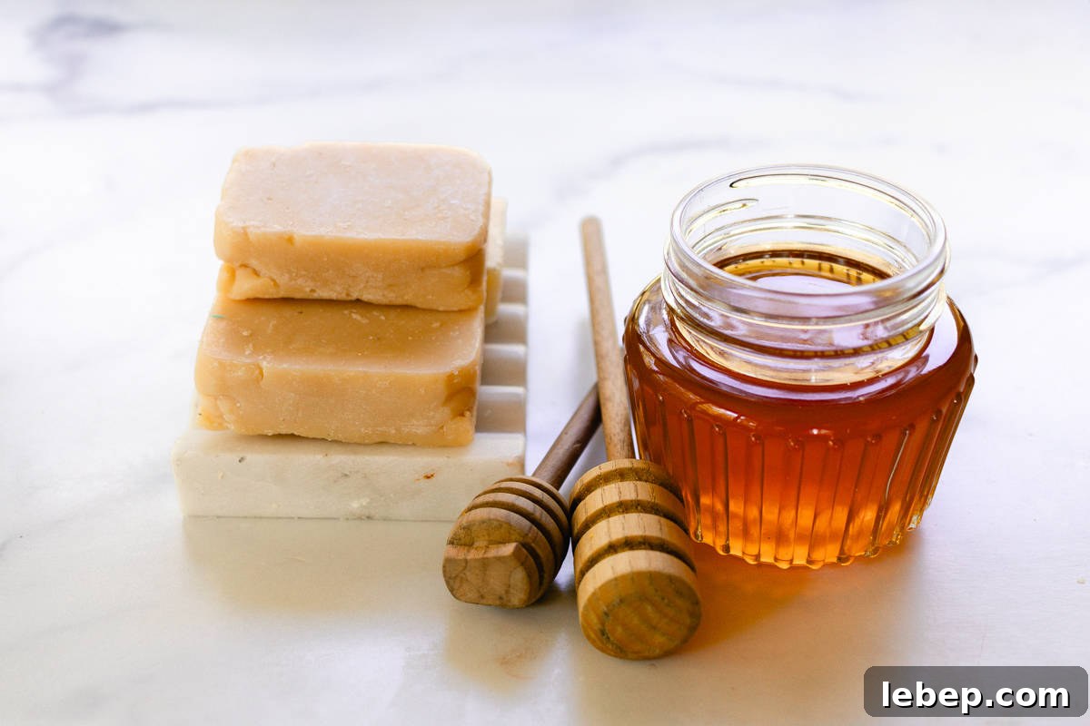 A small stack of soap bars made with honey on a soap rack.