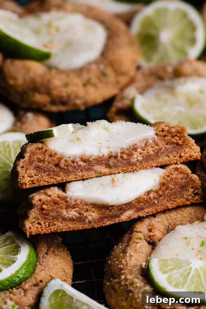 Key Lime Pie Cookies with Make-Ahead Prep Tips 3 A stack of two halves of the key lime cookies, showing the chewy texture inside and the creamy filling.