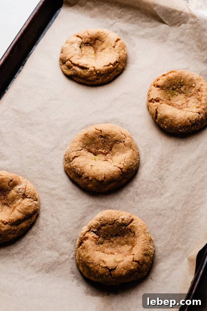 Key Lime Pie Cookies with Make-Ahead Prep Tips 7 The baked cookies cooling on a baking sheet, with indents pressed into the center of each.