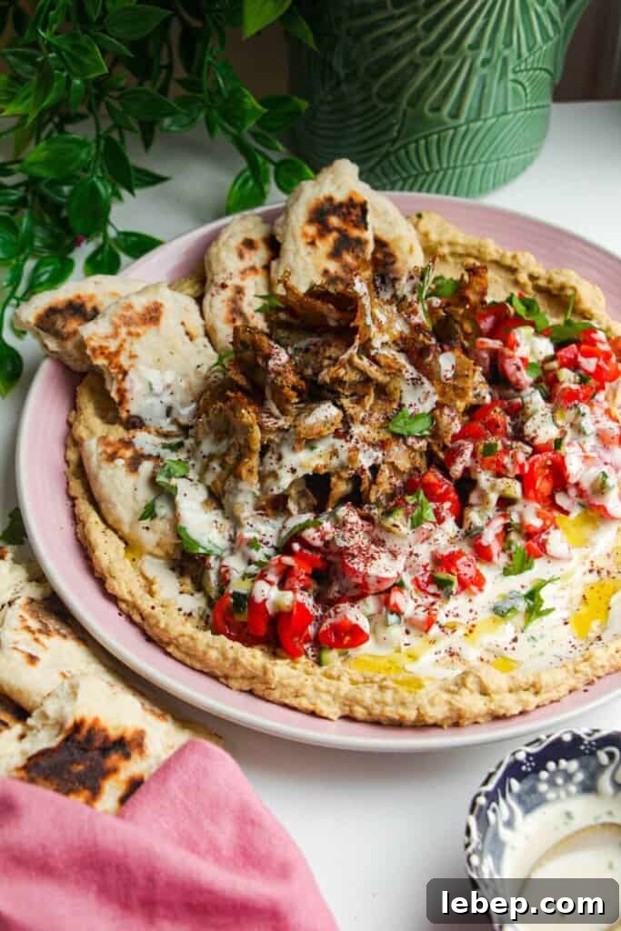 Chicken doner with salad, flatbreads and hummus.