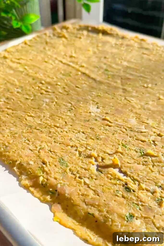Rolled out doner mixture on parchment paper.