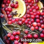 overhead shot of Simmering Holiday Potpourri in a black slow cooker