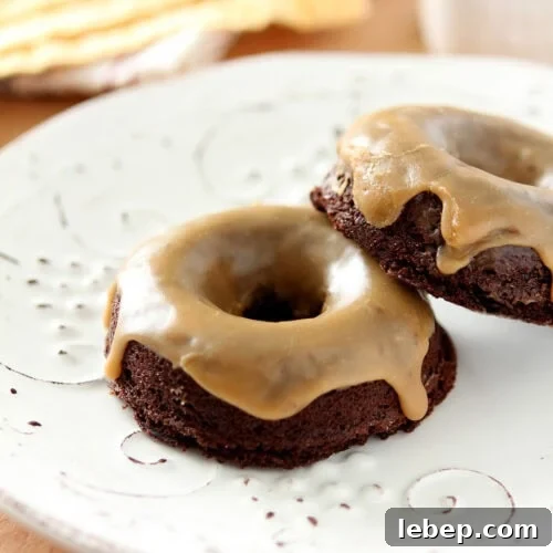 Pair of Baileys Salted Caramel Espresso Doughnuts on a white plate.