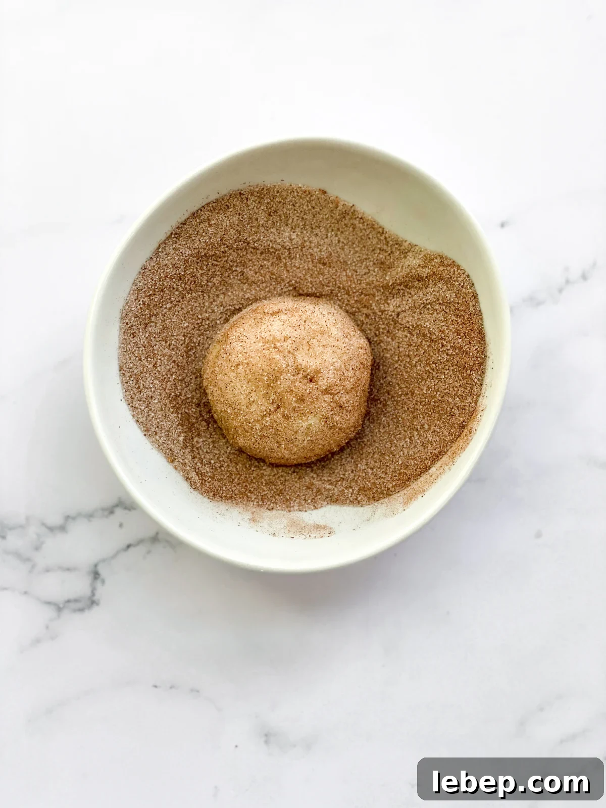 Snickerdoodle Cookies Without Cream of Tartar — Soft, Cinnamon-Sugar Recipe 9 dough ball in cinnamon sugar mixture
