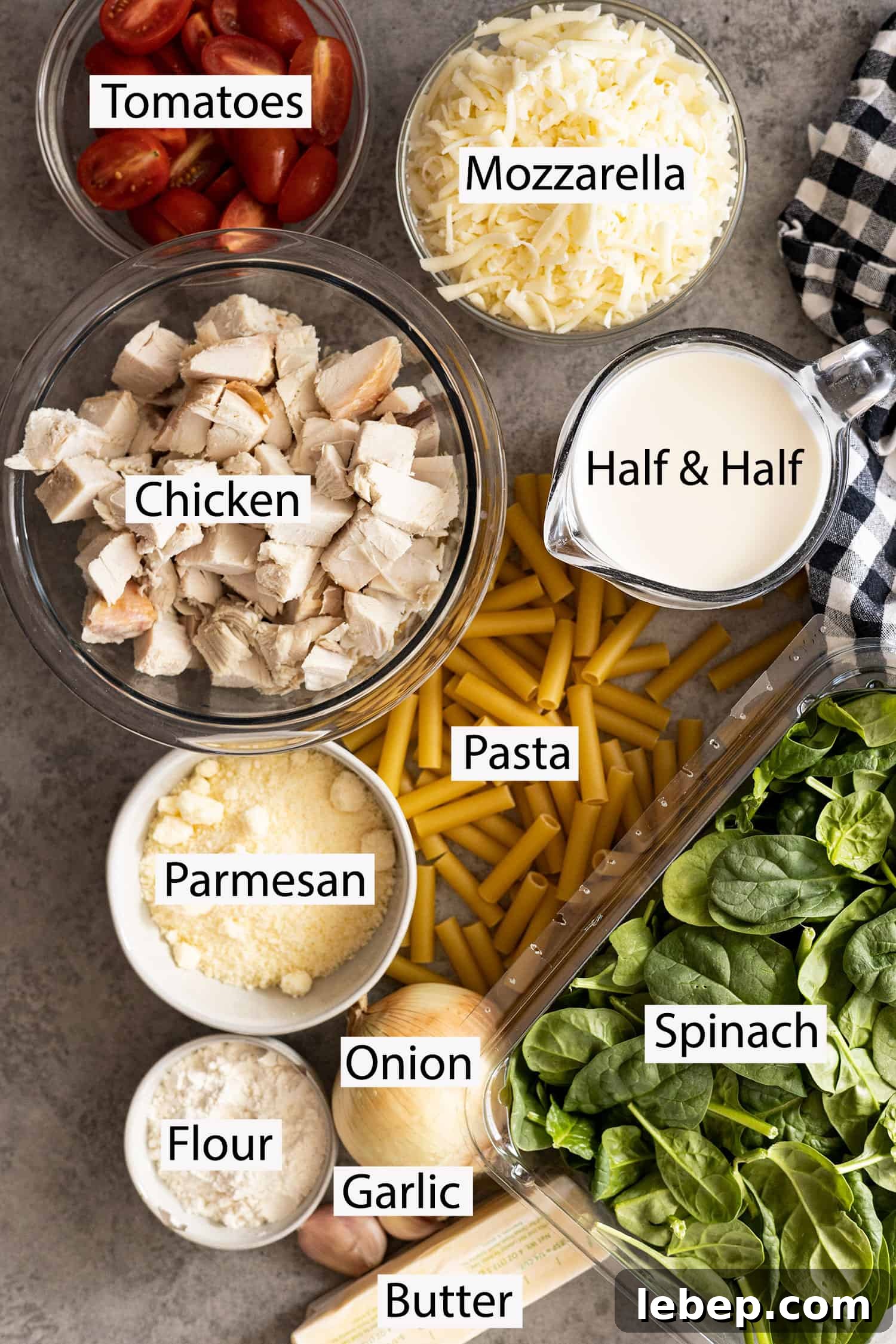 Creamy Chicken Florentine Pasta Bake Recipe 3 Ingredients: Chicken, tomatoes, cheeses, half and half, pasta, spinach, onion, garlic, flour, butter.