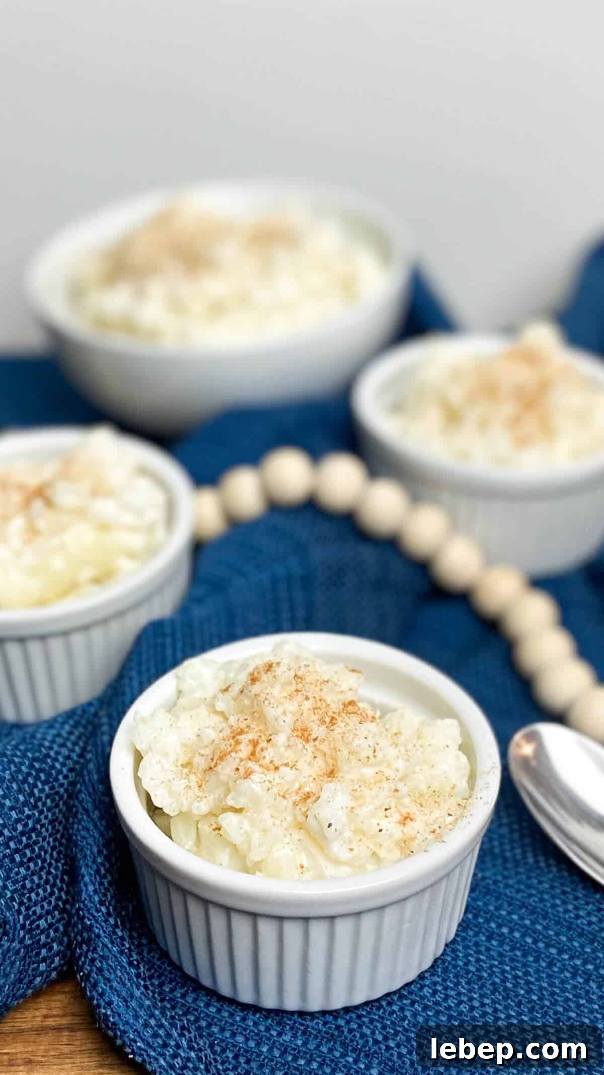 Creamy Homemade Rice Pudding Recipe with Vanilla and Cinnamon 2 Pudding served in small bowls, with a spoon.