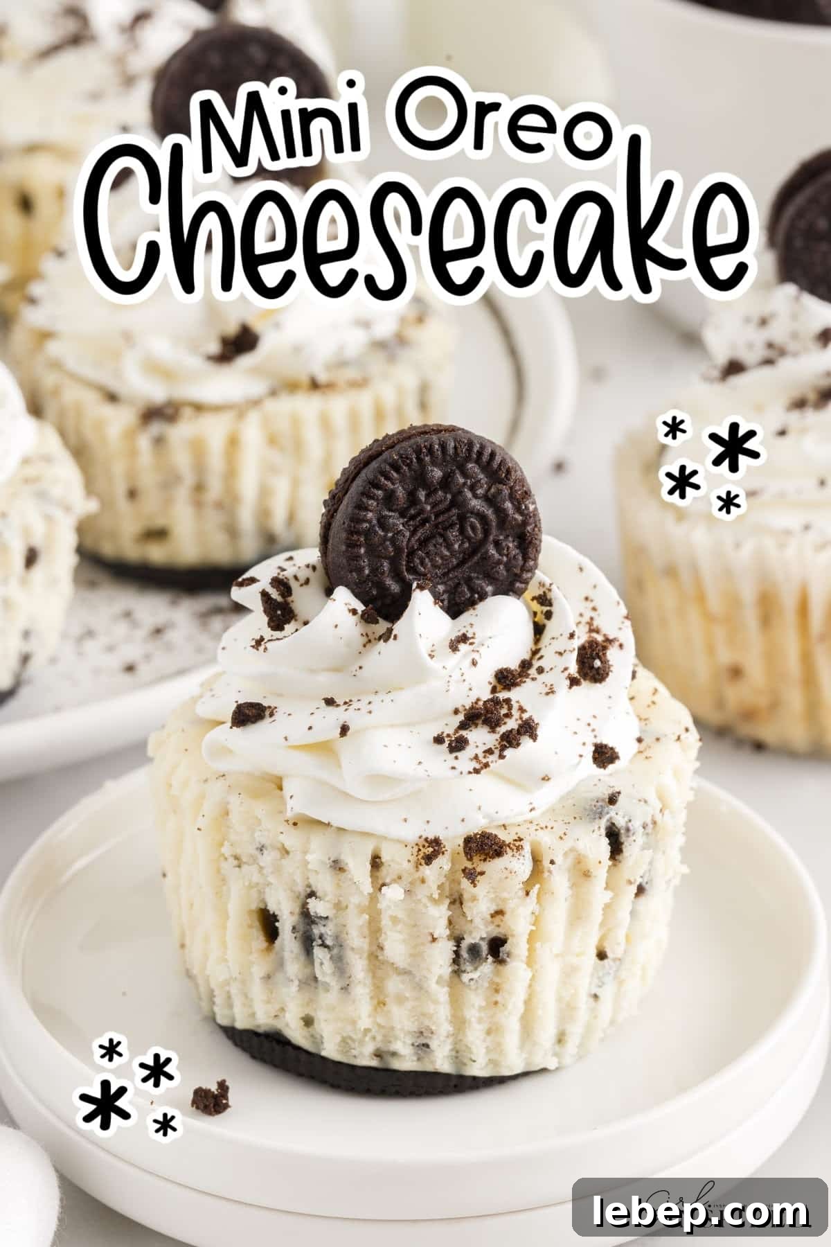 Mini Oreo Cheesecake on a plate topped with whipped cream and an oreo cookie, with text overlay.