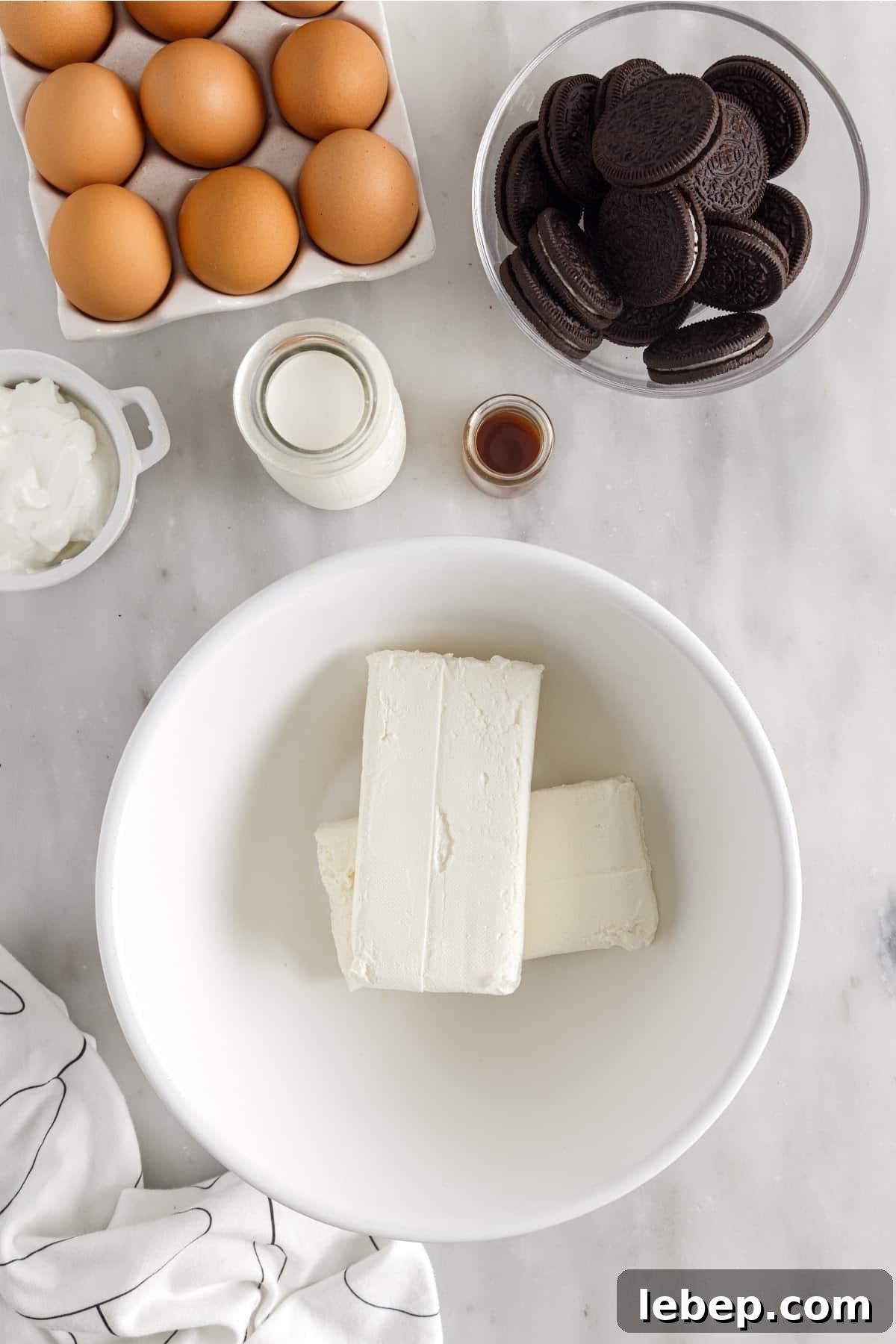 Two blocks of cream cheeses in a bowl to be mixed.