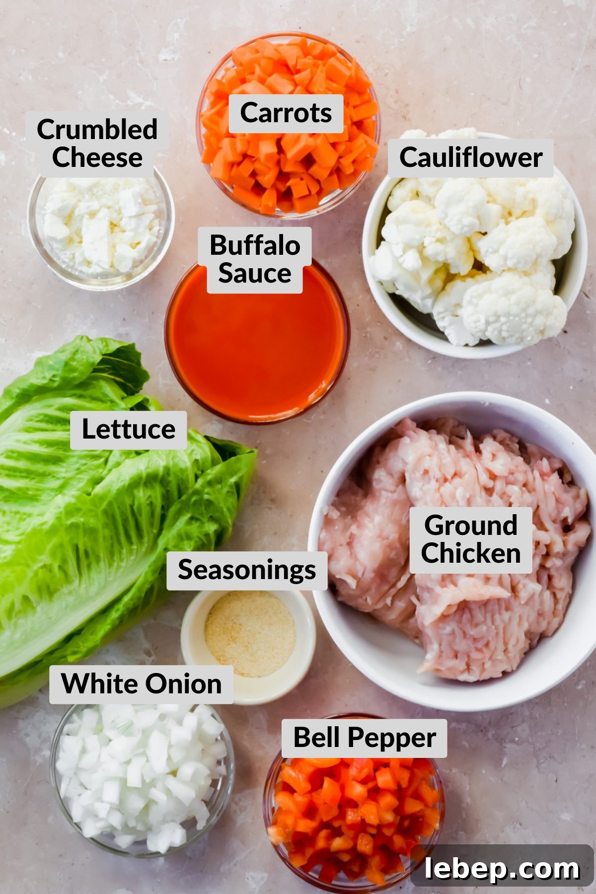 individual bowls of ingredients for buffalo cauliflower chicken lettuce wraps.