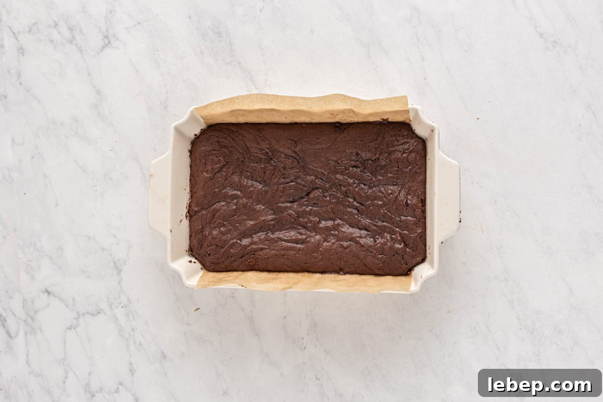 S'mores Brownies Recipe: Gooey Chocolate Graham Bars 6 a square of chocolate brownie in a baking dish.