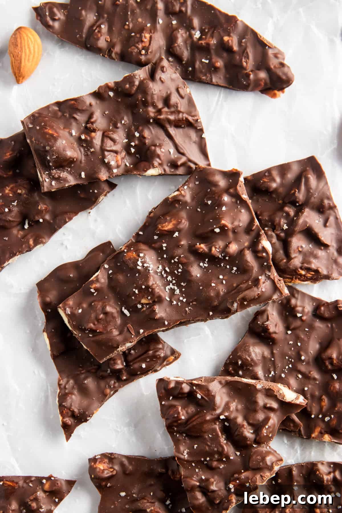 Dark Chocolate Almond Bark pieces on parchment paper.