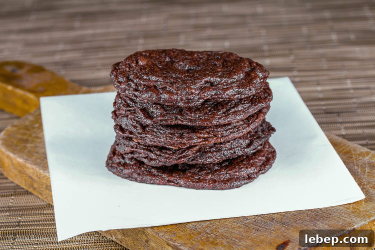 Crispy Gluten-Free Chocolate Cookies with a Surprise Ingredient 4 stack of cookies on parchment; Secret Ingredient Crispy Chocolate Cookies © 2019 Jane Bonacci, The Heritage Cook