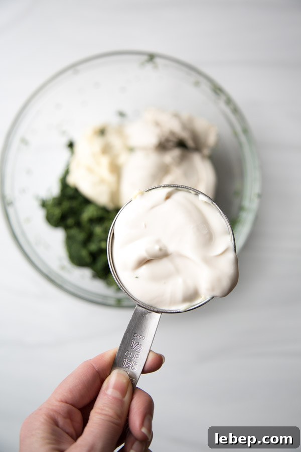 Creamy Warm Spinach Dip — Dairy- and Gluten-Free Recipe 4 cup of dairy-free sour cream over bowl of spinach dip ingredients