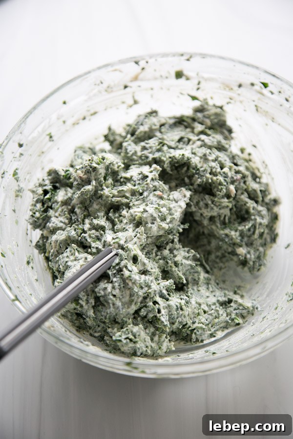 Creamy Warm Spinach Dip — Dairy- and Gluten-Free Recipe 5 gluten-free spinach dip mixing in a bowl