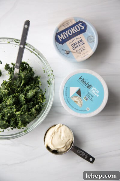 Creamy Warm Spinach Dip — Dairy- and Gluten-Free Recipe 6 bowl of spinach next to cream cheese and sour cream