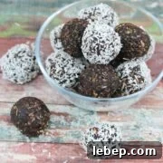 Chocolate coconut energy balls with dates in a glass bowl.