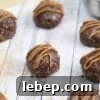 Chocolate balls with dairy-free caramel sauce piped onto them.