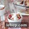 Paleo berry crumble in a white ramekin with pecans around it.