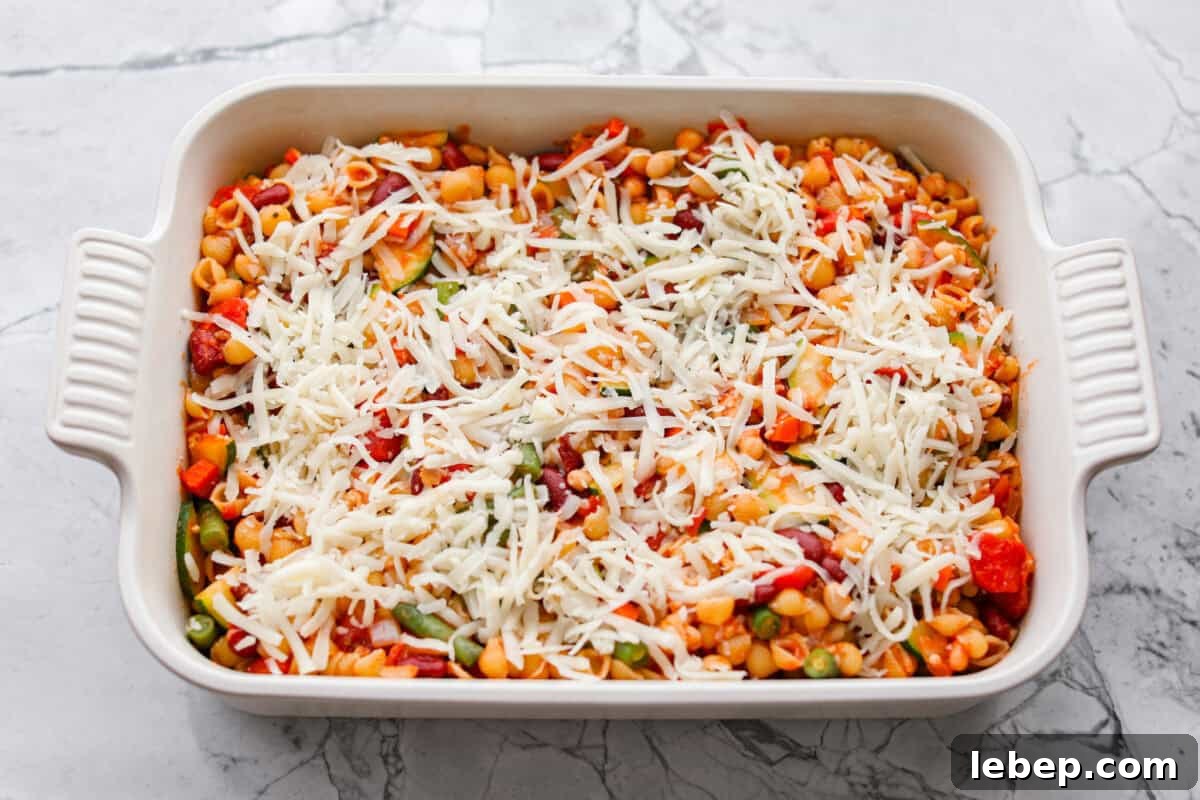 If you love my minestrone soup even a little, you have to try this minestrone casserole. It takes the cozy, veggie packed soup you already love and turns it into a hearty, cheesy pasta bake. It feels like weeknight dinner perfection. All of the ingredients mixed together and spread out in a casserole dish and topped with cheese.