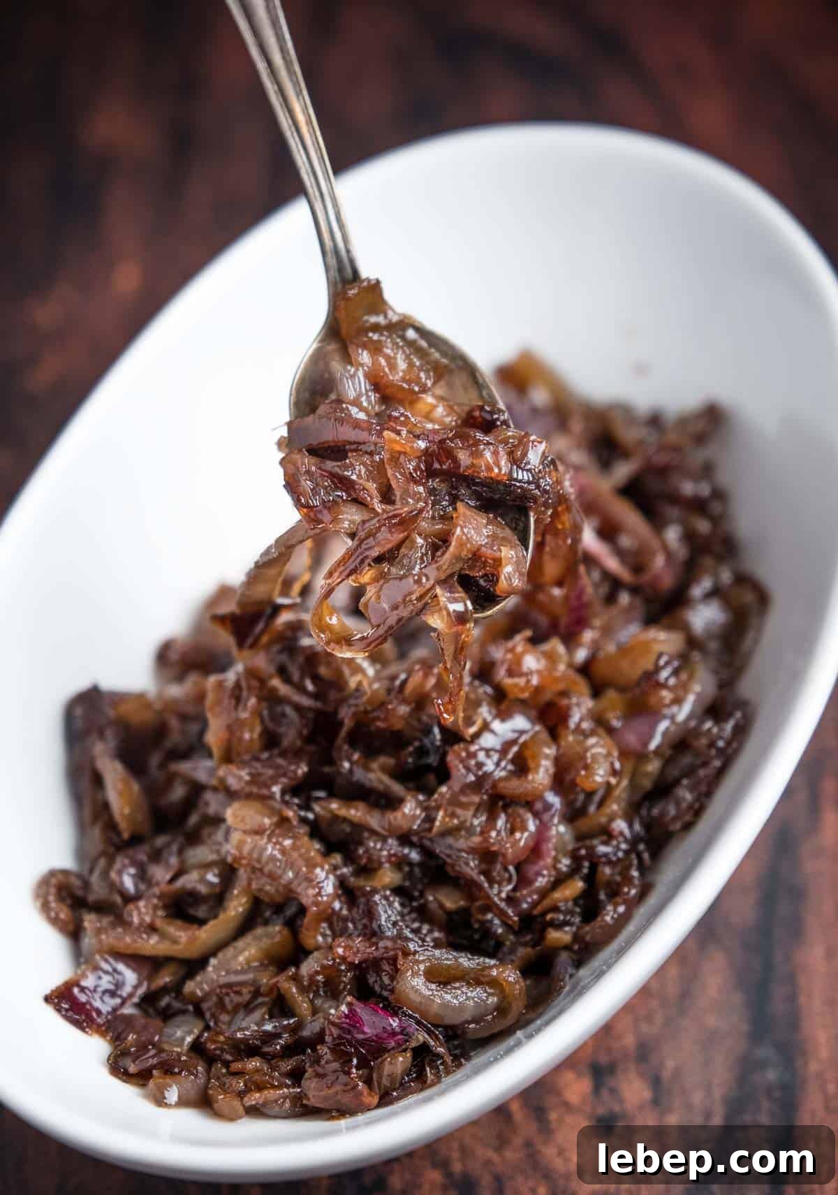 Maillard Reaction: How It Creates Flavor and Browning in Food 4 Caramelized onions in a bowl being lifted out with a spoon.