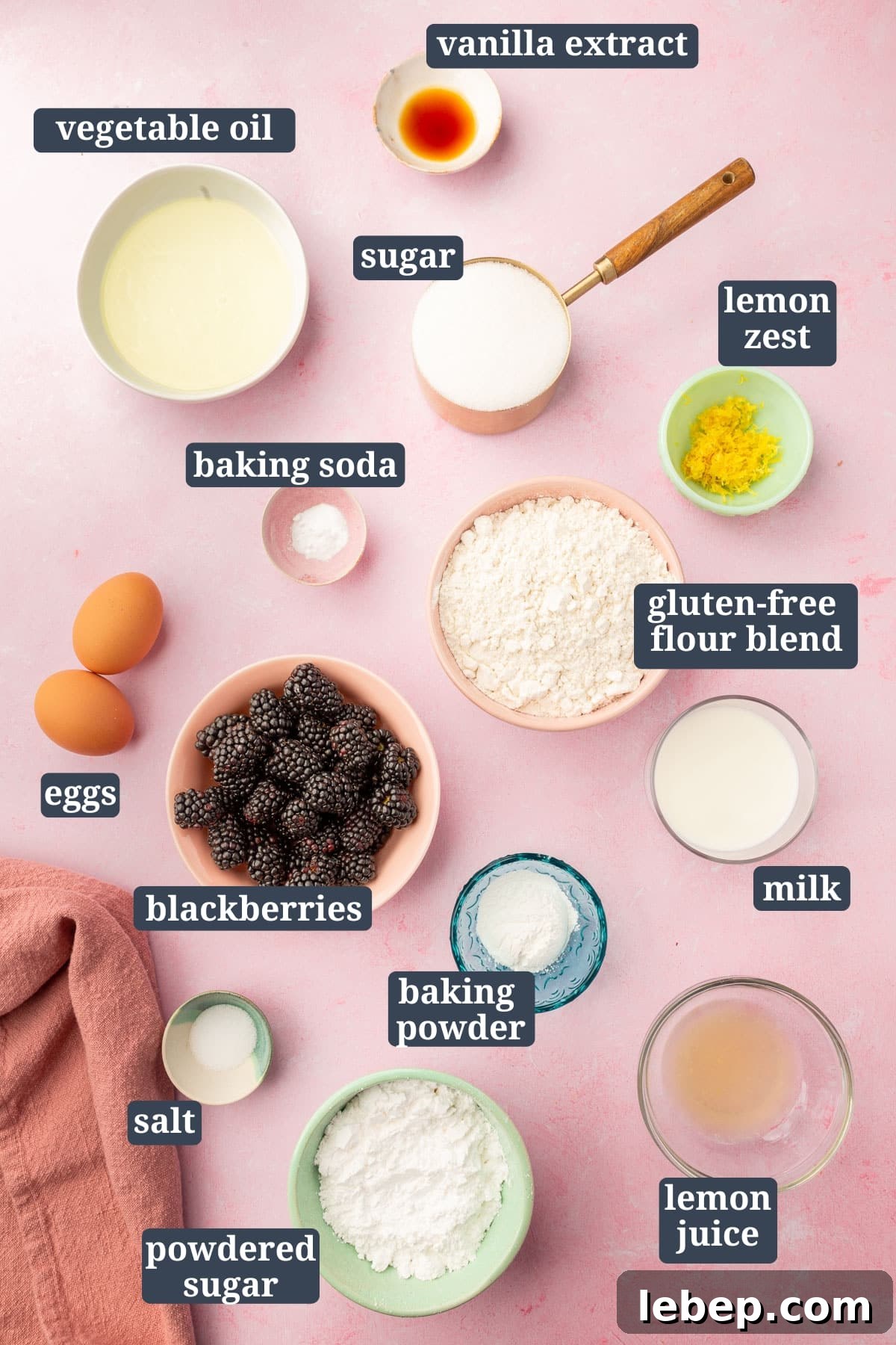 An overhead view of small bowls of ingredients to make gluten free blackberry muffins.