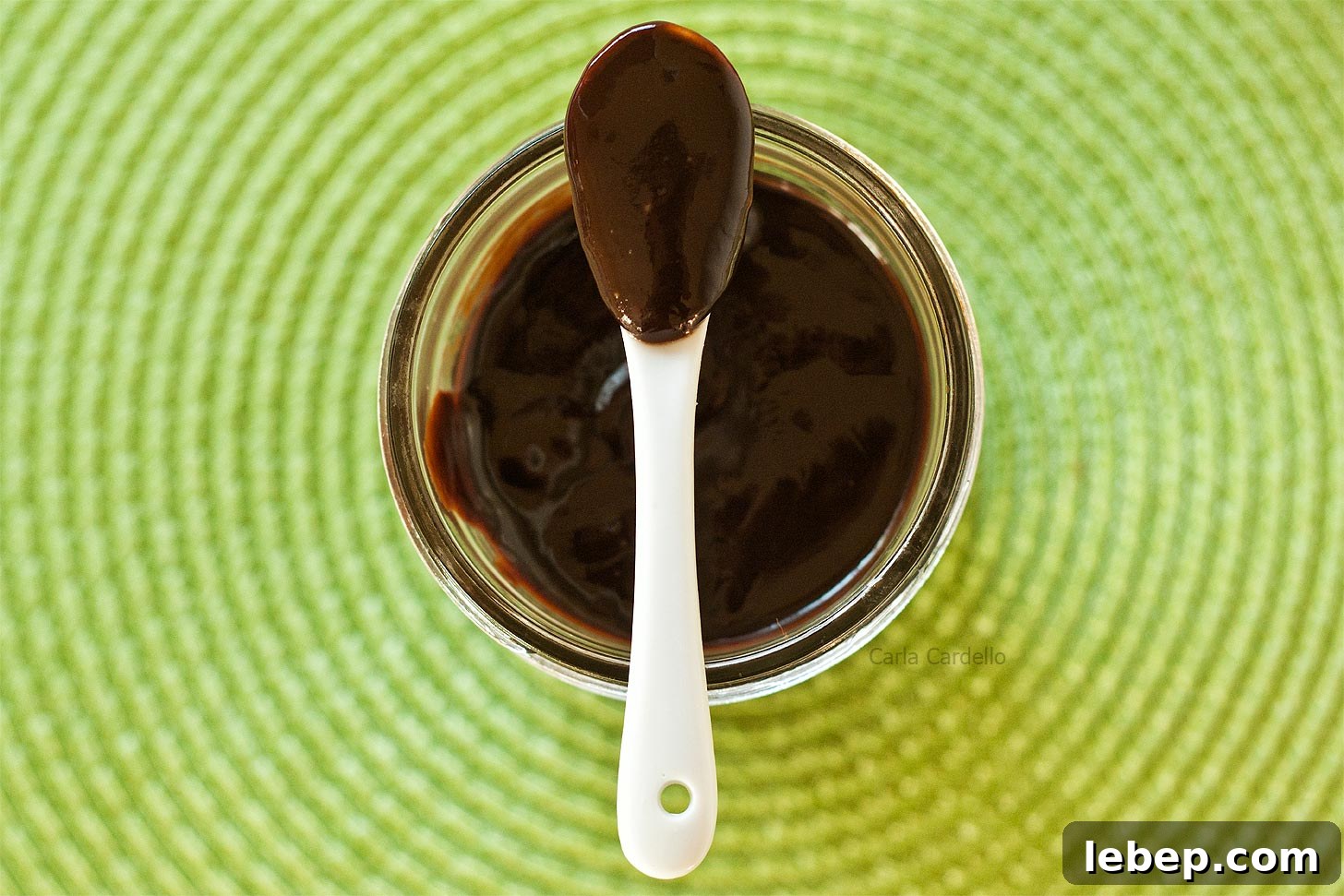 Spoon on top of jar with Nutella sauce