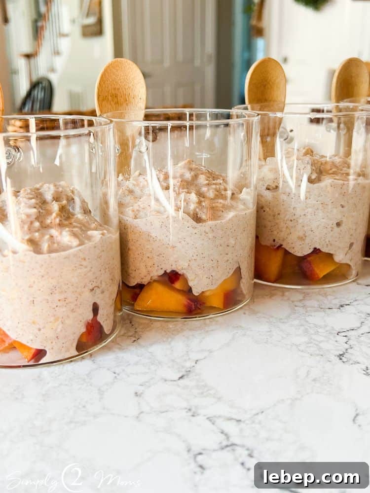 Peach Cobbler Overnight Oats (THM-E) — Make Ahead Recipe 7 Overnight oats jars with diced peaches and oats mixture lined up on a counter.
