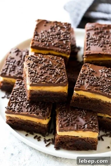 Peanut butter brownies with a chocolate brownie base, peanut butter frosting and fudge topping.