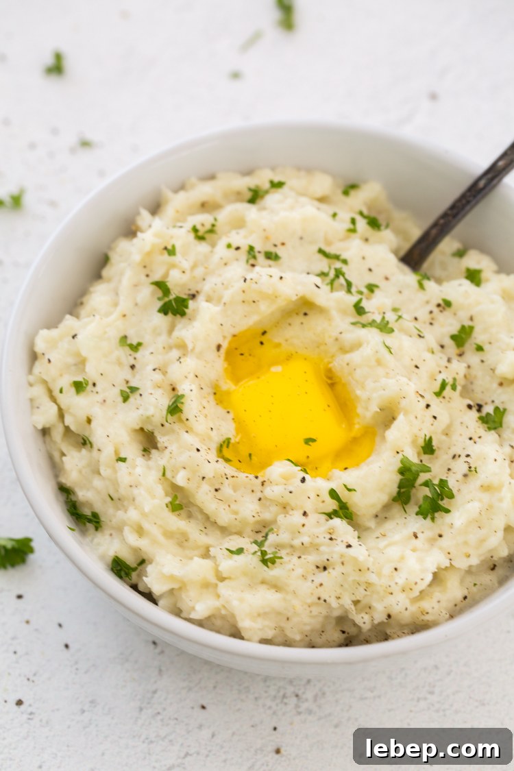 Instant Pot Mashed Cauliflower — Keto & Gluten-Free Recipe 2 Instant Pot Mashed Cauliflower with a spoon, butter and parsley