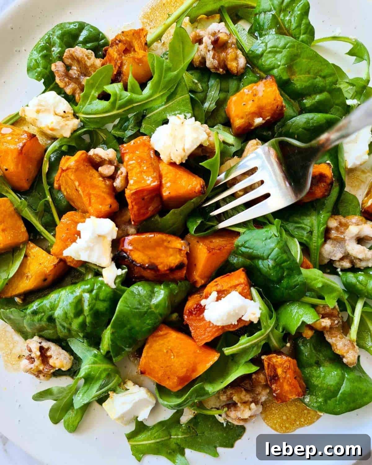 Roasted Pumpkin, Spinach & Goat Cheese Salad Recipe 2 Close up of a plate of pumpkin salad with a fork
