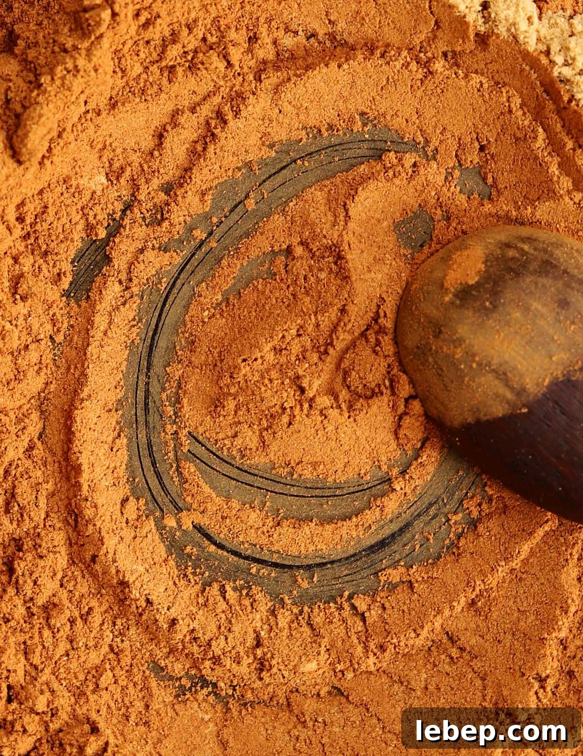 Homemade Pumpkin Pie Spice Blend for Baking & Lattes 3 homemade pumpkin pie spices on a black plate blending together with a spoon