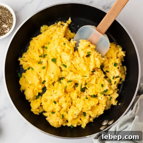 Creamy Cottage Cheese Ranch Dip Recipe for Parties and Snacks 12 An overhead image of cottage cheese scrambled eggs cooked on a skillet.