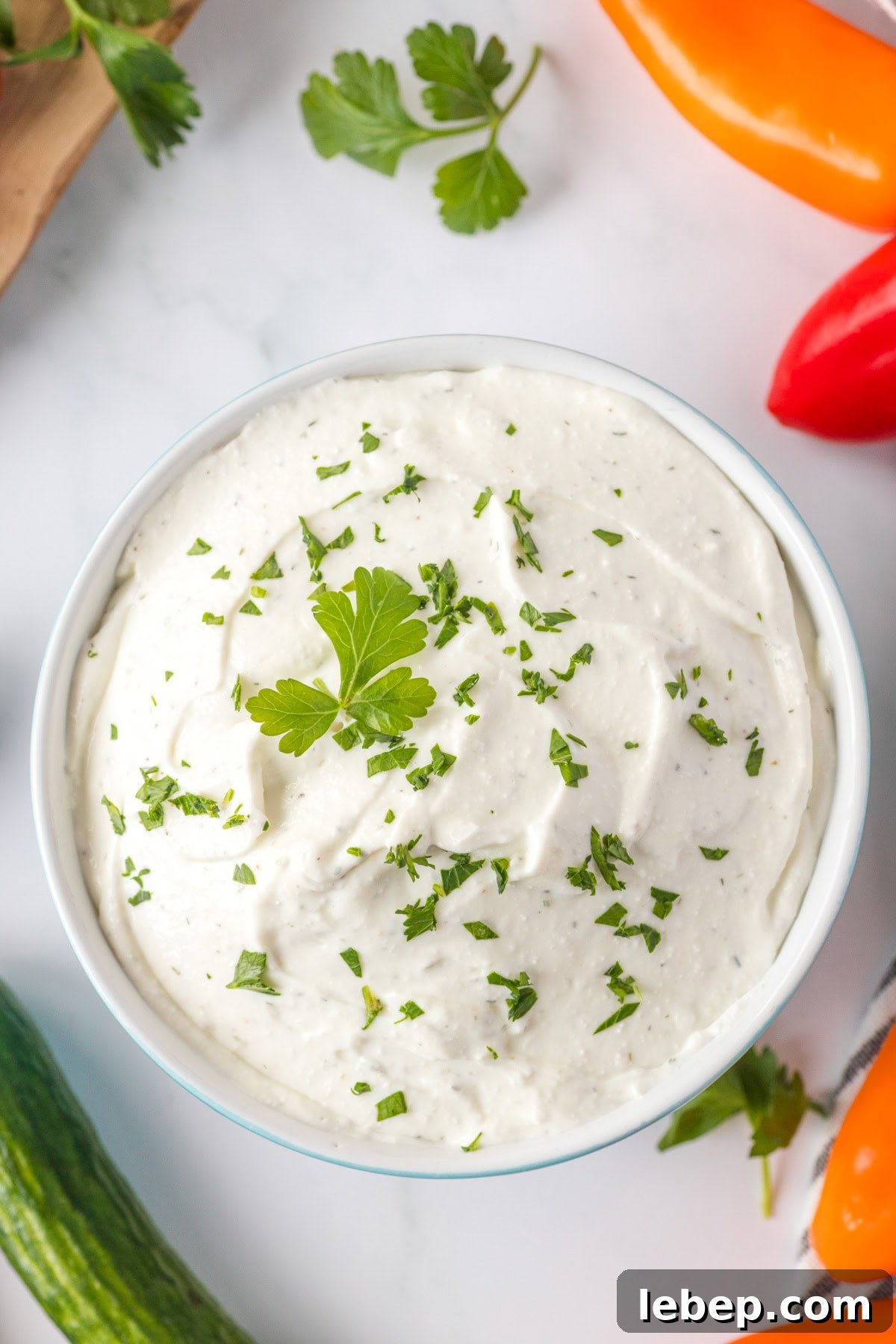 Creamy Cottage Cheese Ranch Dip Recipe for Parties and Snacks 7 An overhead image of cottage cheese ranch dip in a bowl with fresh parsley on top.
