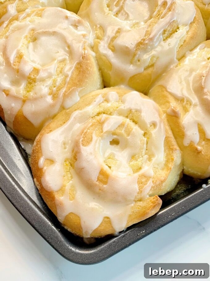 A pan of Overnight Orange Rolls with orange glaze.