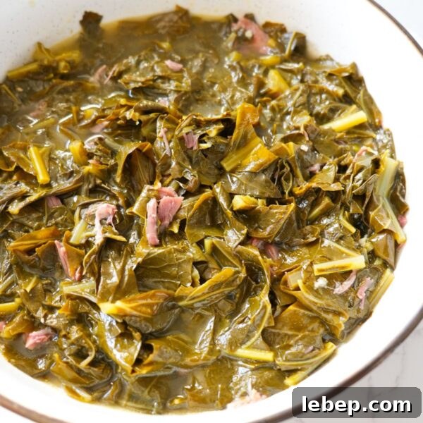 Tender soul food collard greens with smoked meat and savory broth.