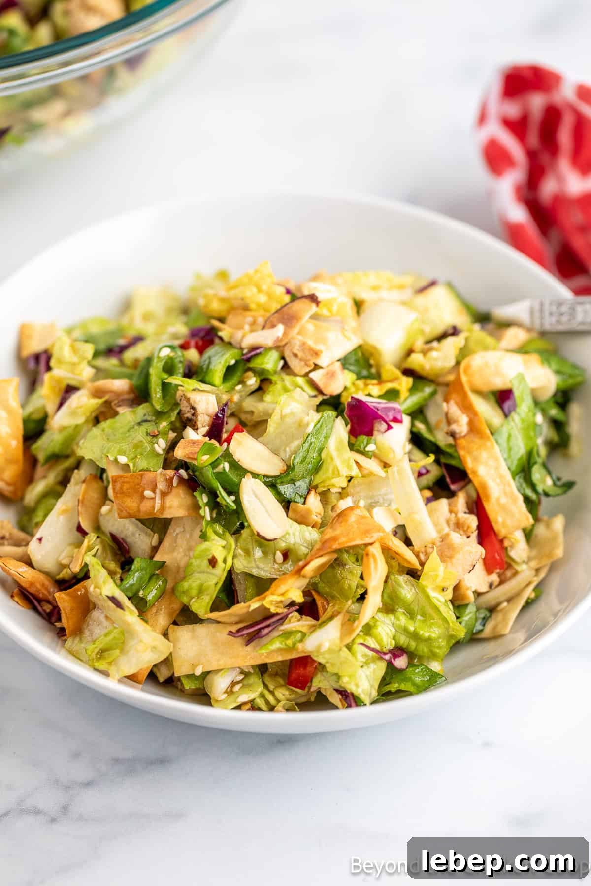 Crispy Asian Chicken Salad with Sesame Ginger Dressing 10 A chopped salad in a white bowl.