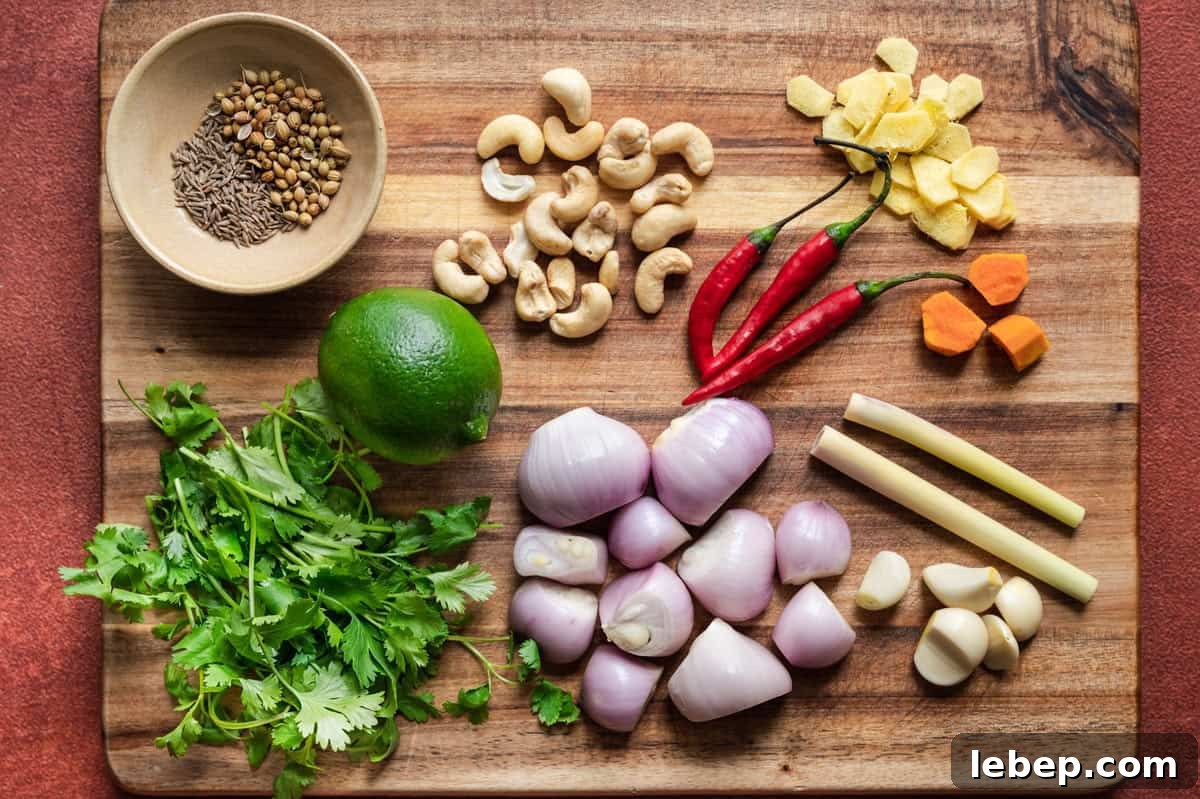 Ingredients for Malaysian laksa paste laid out on a wooden cutting board.