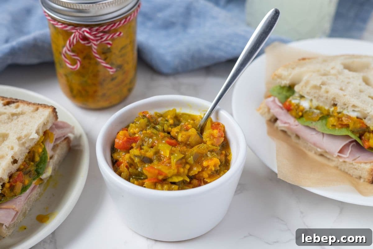 Homemade Mustard Relish Recipe for Tangy Sandwiches and Burgers 2 Mustard relish in a bowl with a spoon after being added to a sandwich.