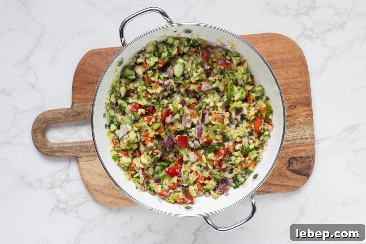 Homemade Mustard Relish Recipe for Tangy Sandwiches and Burgers 5 Draining excess water out of chopped vegetables in a colander.