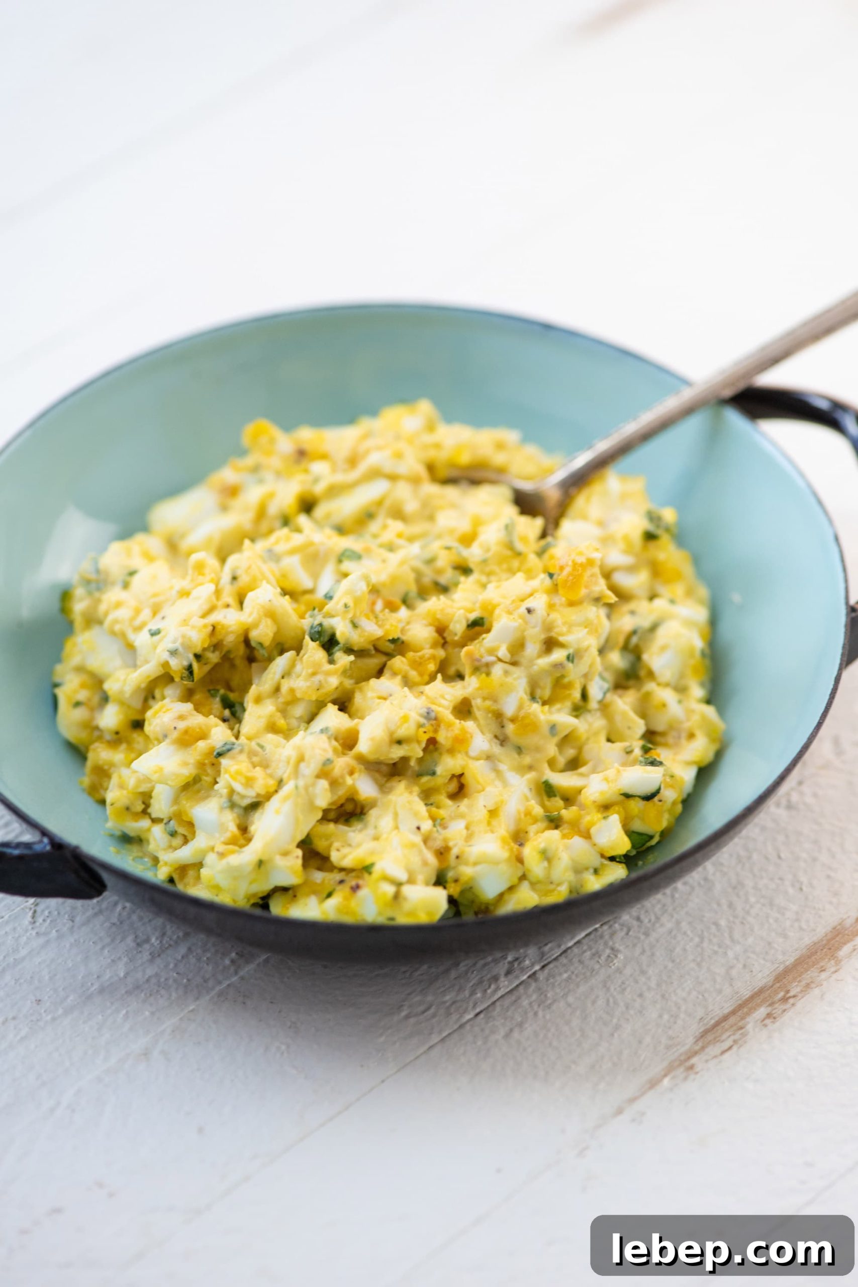 Cooking with Basil: 12 Flavorful Ways to Use Fresh Basil in Meals 10 A blue bowl with orange basil egg salad.