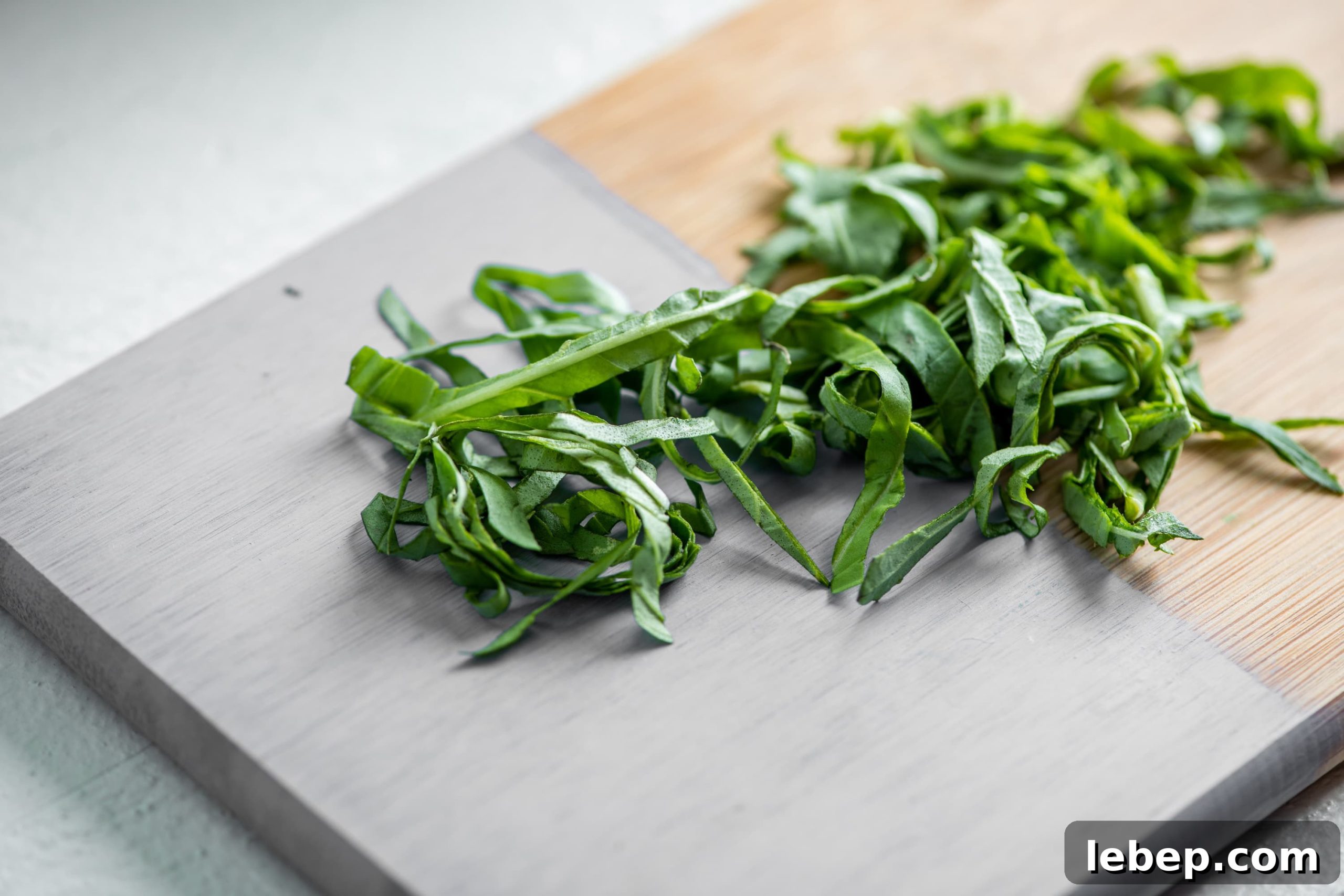 Cooking with Basil: 12 Flavorful Ways to Use Fresh Basil in Meals 8 Thinly sliced or chiffonaded basil on a painted cutting baord.