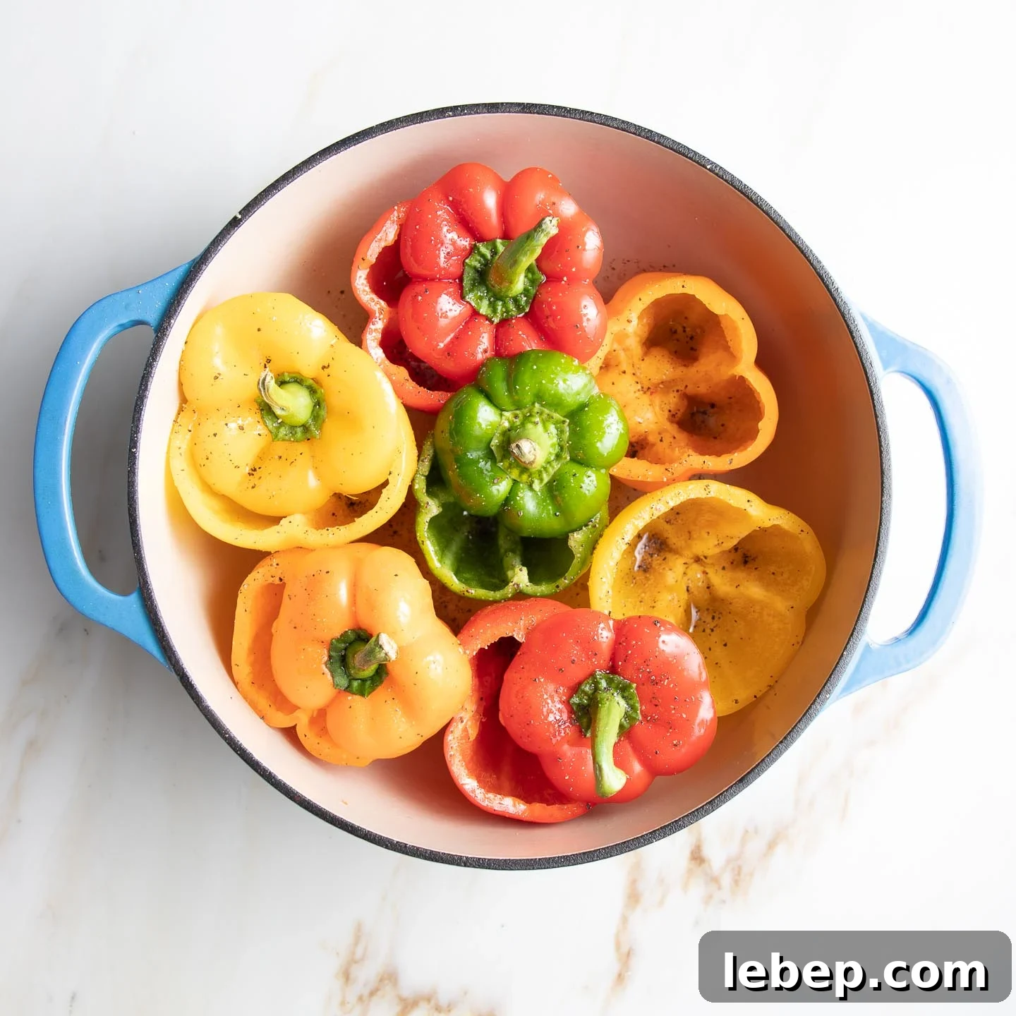 Vegan Lentil-Stuffed Peppers Recipe: Hearty Plant-Based Dinner 7 Red, orange, yellow and green bell peppers, with their tops cut off, fit tightly into a dutch oven so they stand up.