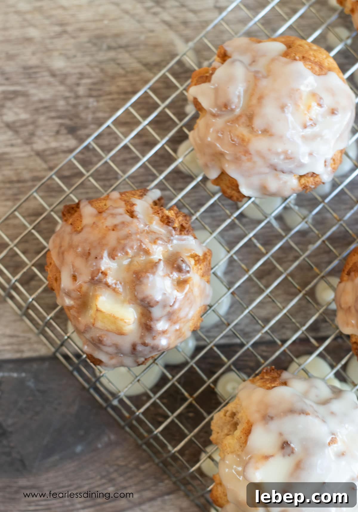 Gluten-Free Apple Fritters: Air Fryer or Classic Fried Recipe 10 The top view of glazed apple fritters on a rack.
